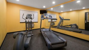 A gym with treadmills, an elliptical, and a stationary bike. - Super 8 by Wyndham Rochester Mayo Clinic Area (Rochester)