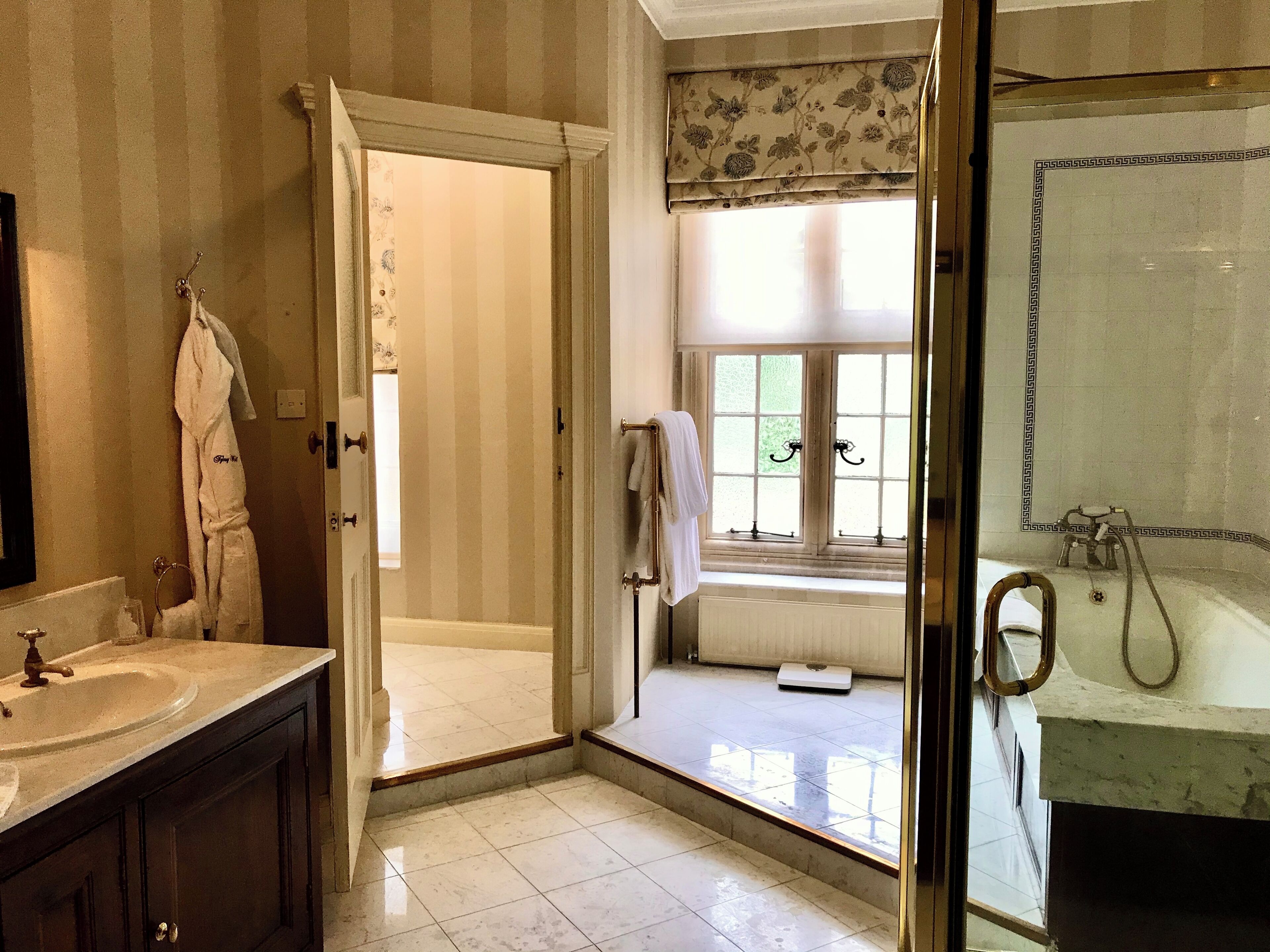 A bathroom with a sink, mirror, and shower.