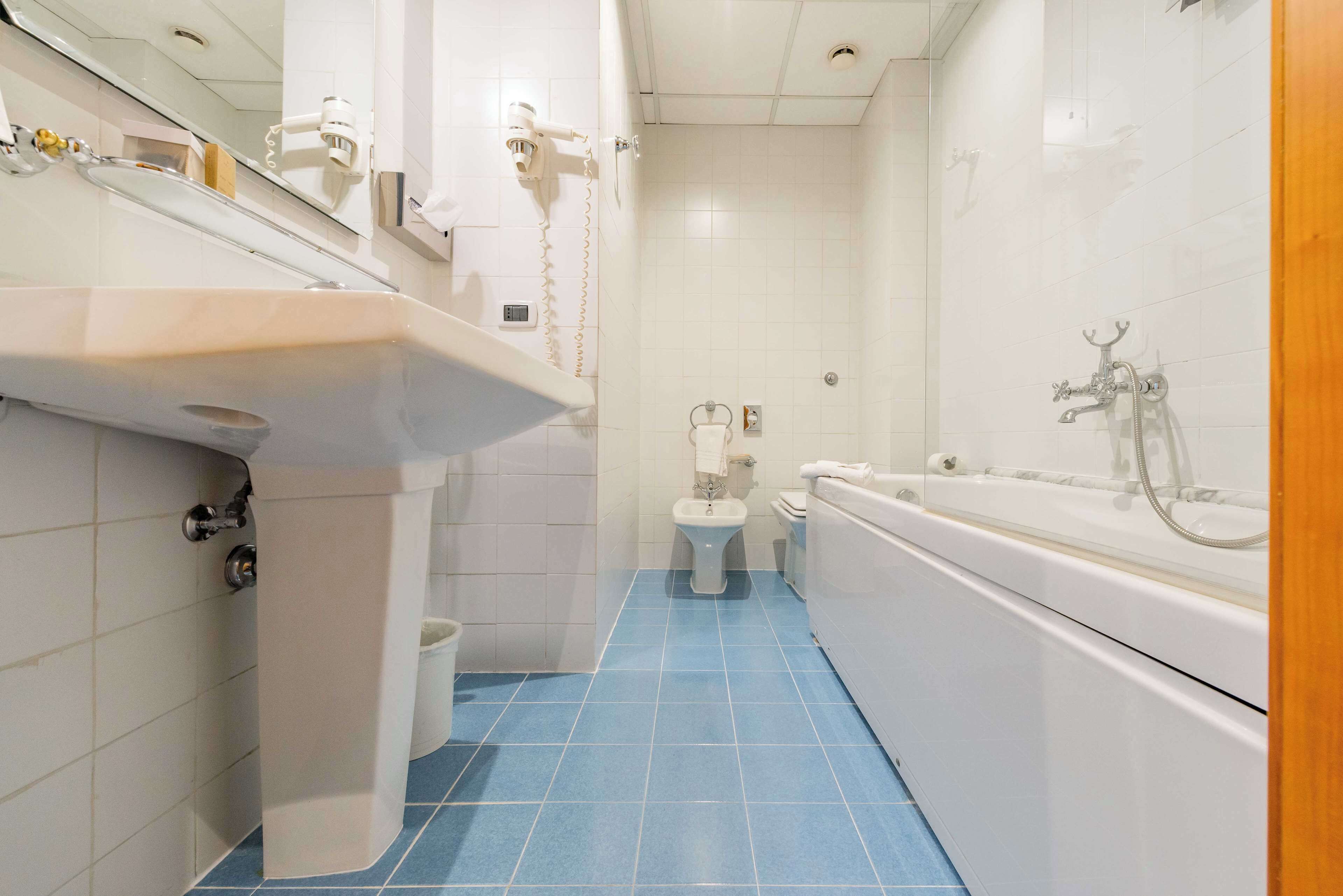 A bathroom with a sink, toilet, and bathtub.