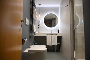 A modern bathroom with a toilet, sink, and mirror. - Best Western Hotel Artdeco (Rome)