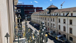 A street view with a building labeled "GAIA" and a construction crane in the distance. - GAIA Hotel Basel - the sustainable hotel (Basel)