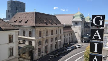 A historic building with a tiled roof, a green dome, and a sign with the letters "GAIA".