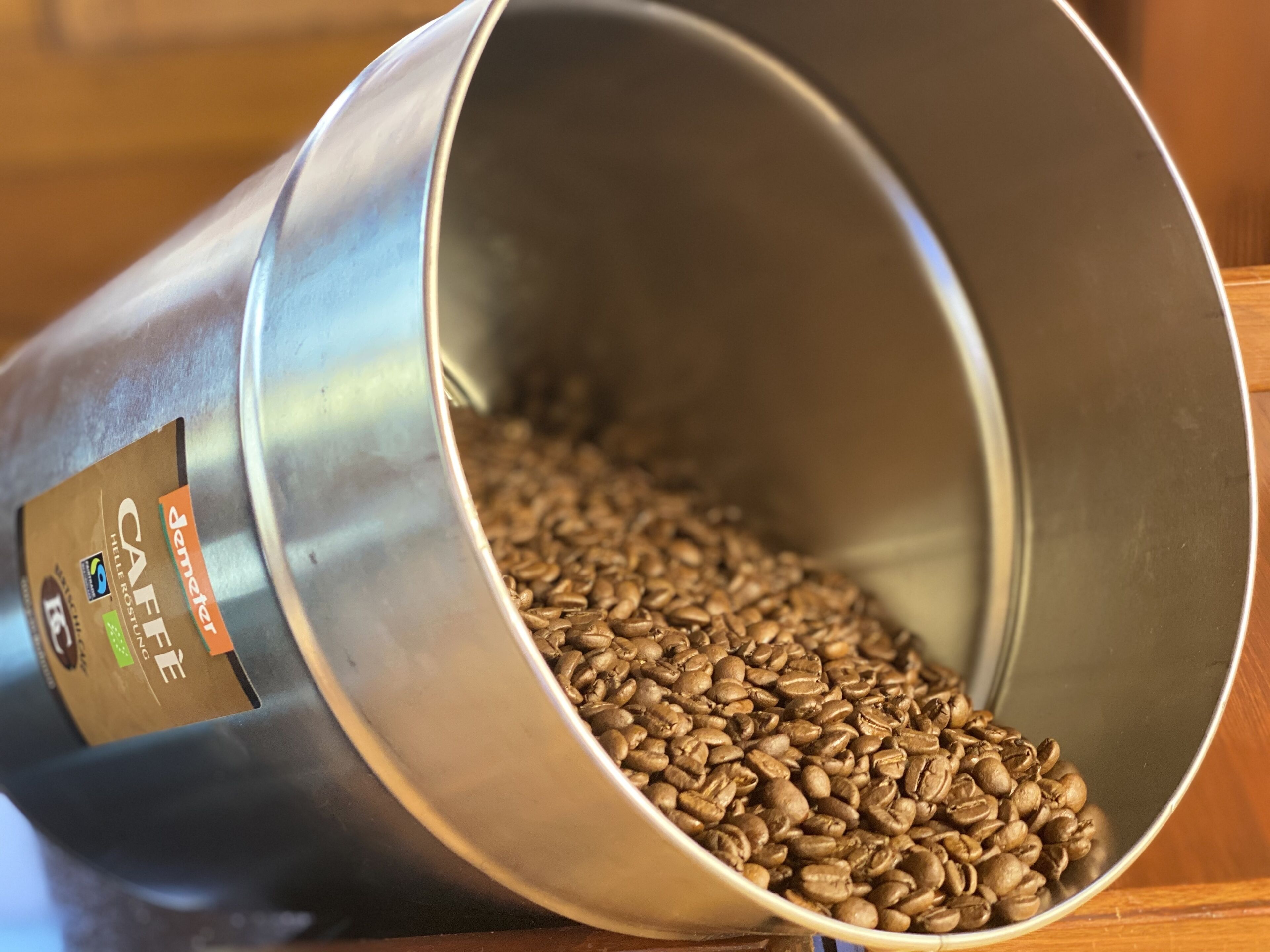 A metal container filled with coffee beans.