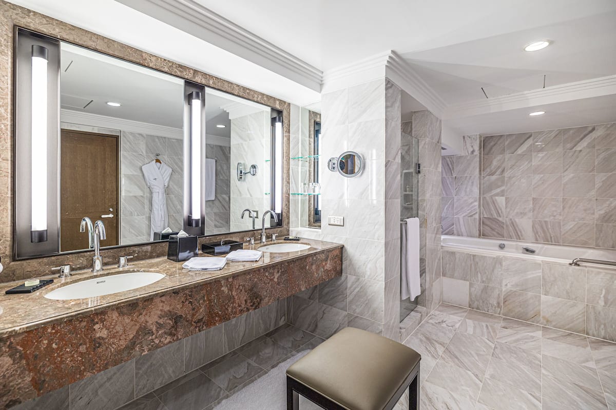 corner suite, one king bed | bathroom | separate bathtub and shower, deep-soaking bathtub, hair dryer, bathrobes