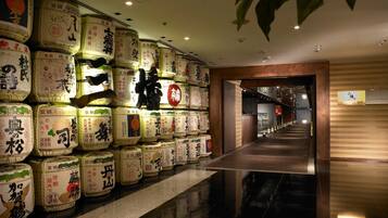 A hallway lined with large, labeled packages, leading to a wooden door.