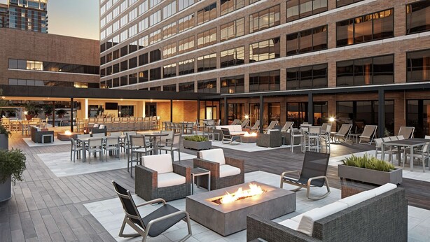 A rooftop patio with outdoor seating, fire pits, and a view of the cityscape. - Hilton Houston Plaza/Medical Center (Houston)