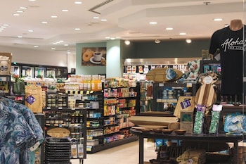 A spacious lobby with a high ceiling, large windows, and a central seating area. at Ala Moana Hotel by Mantra