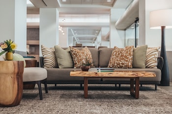 A well-lit store with shelves stocked with various products, including snacks and beverages. at Ala Moana Hotel by Mantra