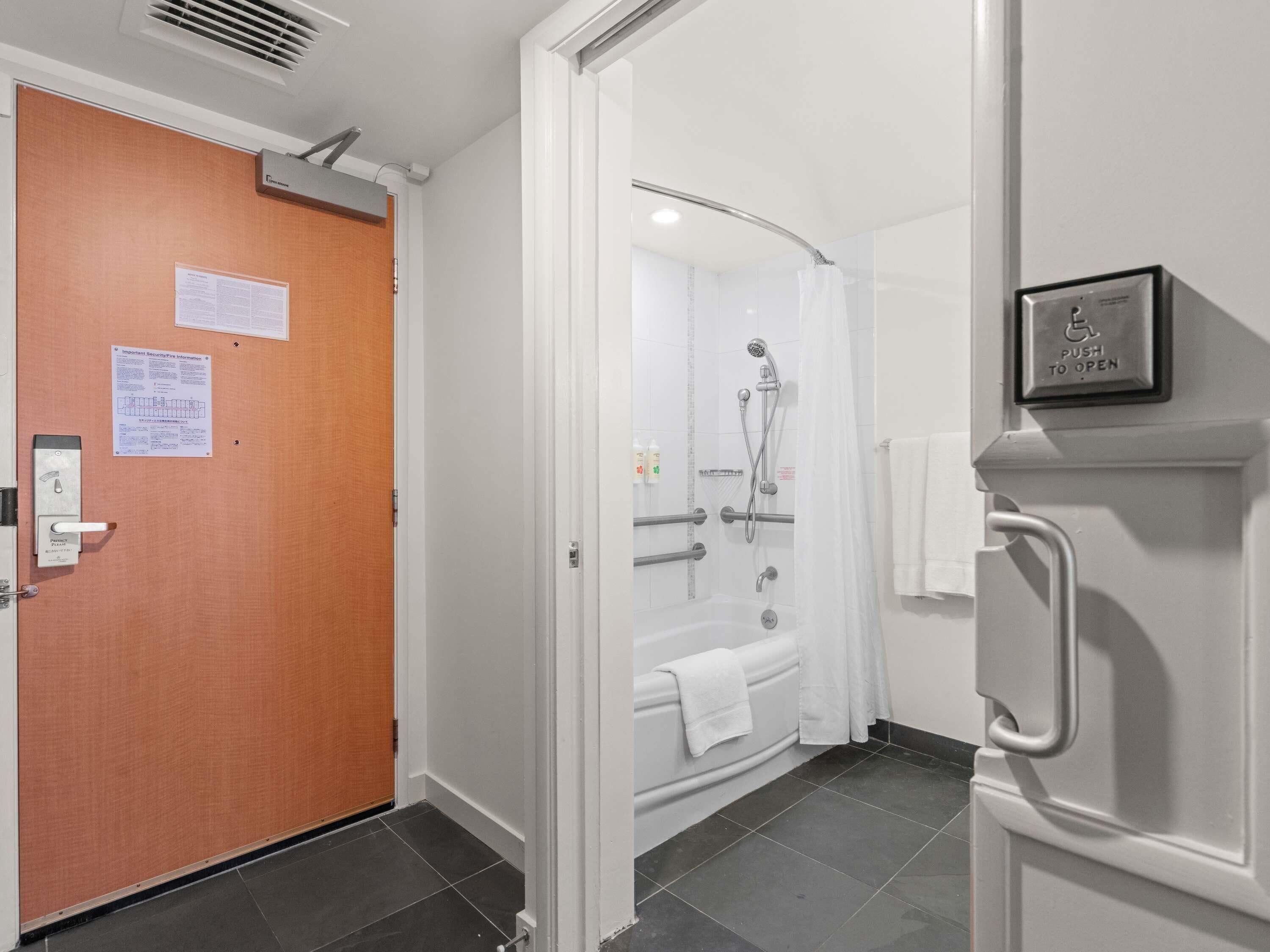 A bathroom with a shower, a toilet, and a sink.