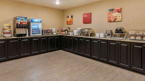 A kitchen with a coffee machine, a refrigerator, and a toaster.