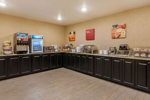 A kitchen with a coffee machine, a refrigerator, and a toaster.