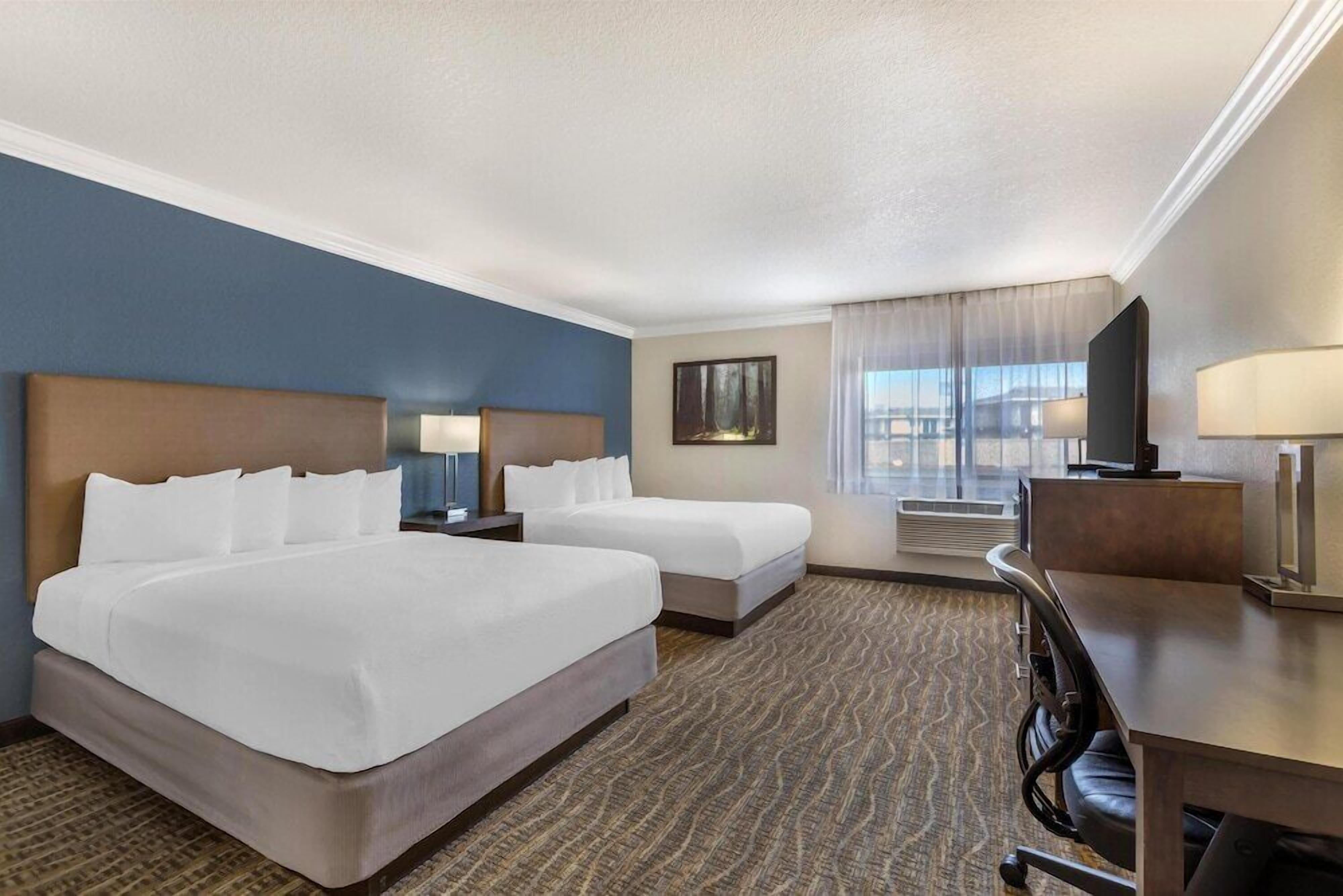 Premium bedding, desk, laptop workspace, iron/ironing board