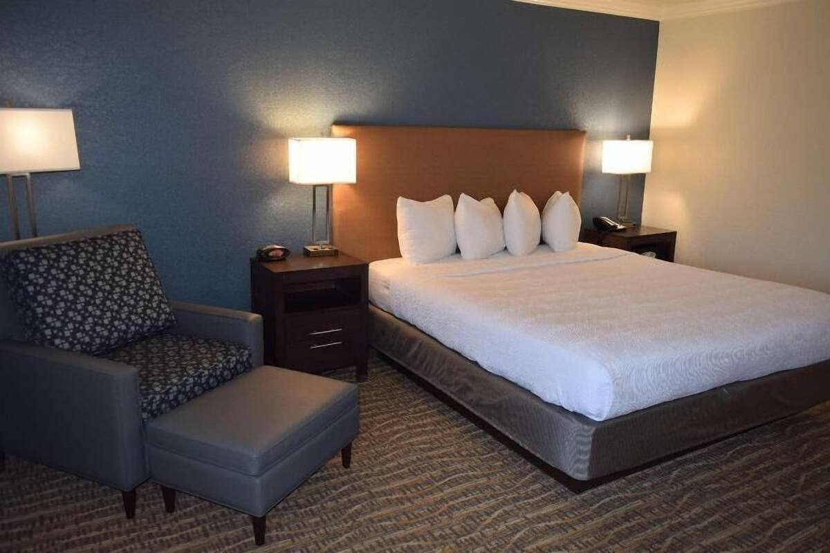 Premium bedding, desk, laptop workspace, iron/ironing board