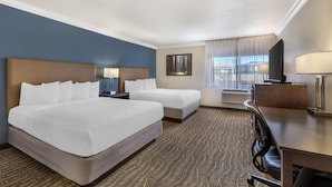 A hotel room with two beds, a desk, a chair, a TV, and a window with curtains. - Best Western Town & Country Lodge (Tulare)