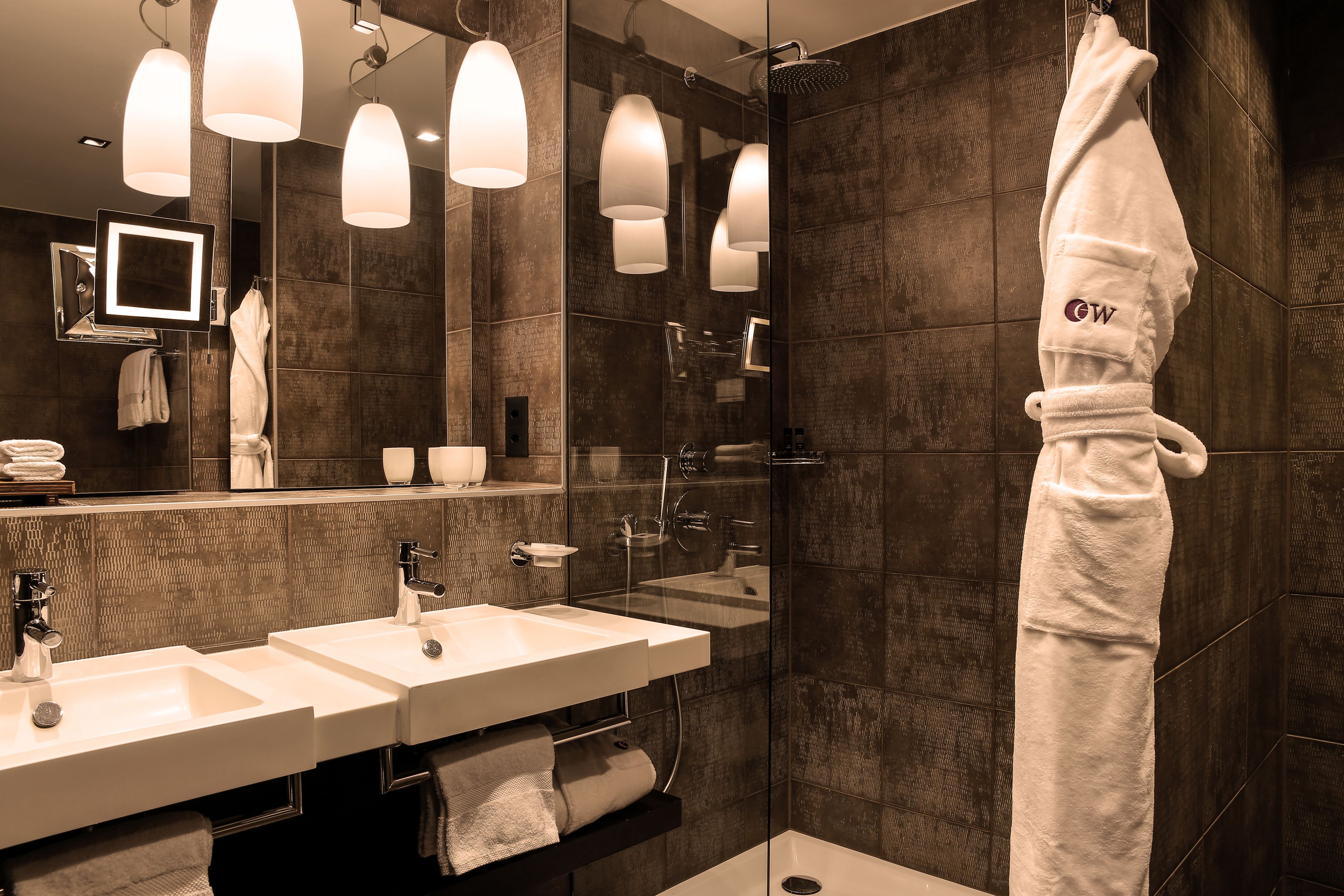 junior suite | bathroom | shower, free toiletries, hair dryer, bathrobes