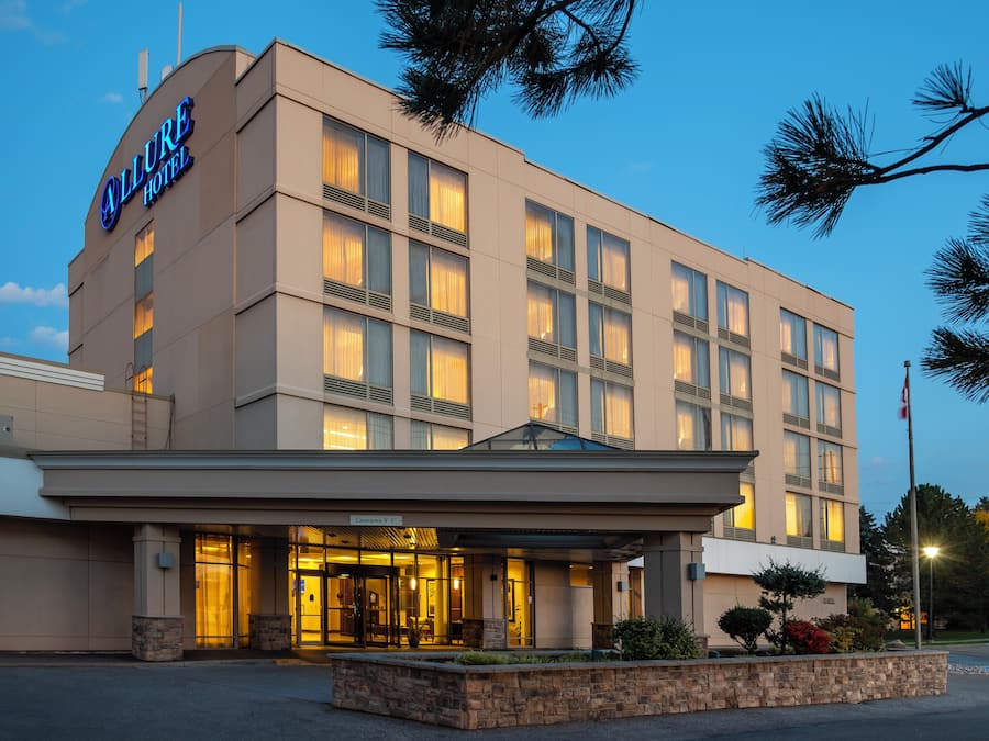 A hotel with a modern facade, a clear entrance, and a sign indicating a clearance of 9'-5'.