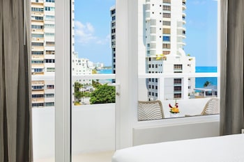 Room, 1 King Bed, Balcony | In-room safe, desk, laptop workspace, blackout drapes at AC Hotel by Marriott San Juan Condado