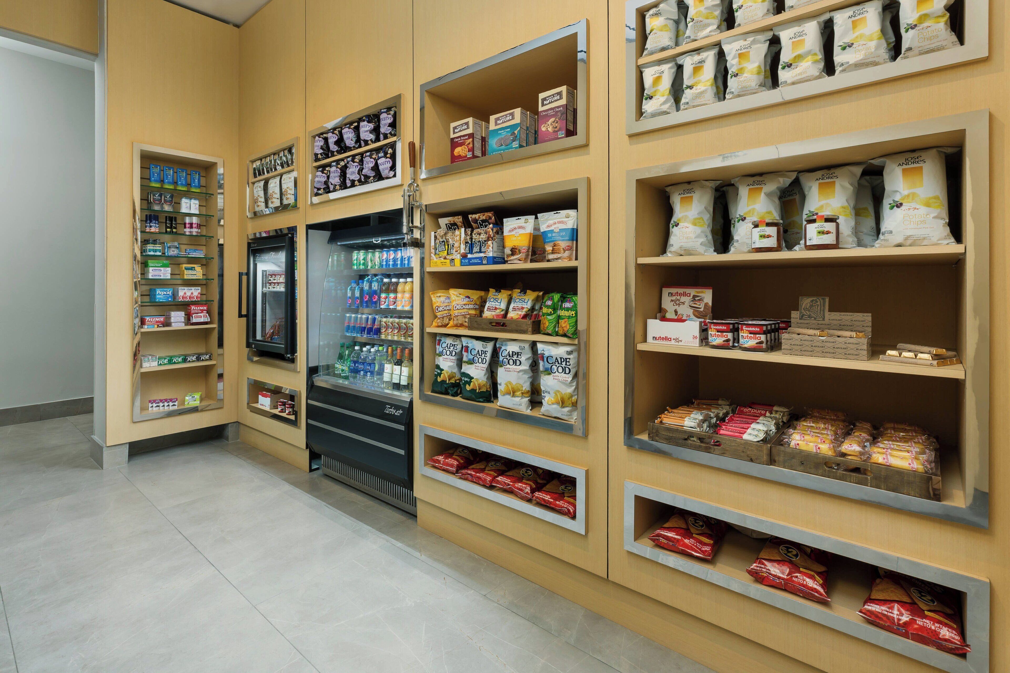A grocery store with shelves stocked with snacks, beverages, and packaged goods.