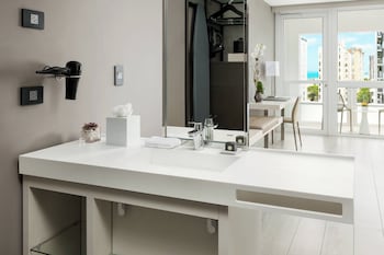 Eco-friendly toiletries, hair dryer, bathrobes, towels at AC Hotel by Marriott San Juan Condado