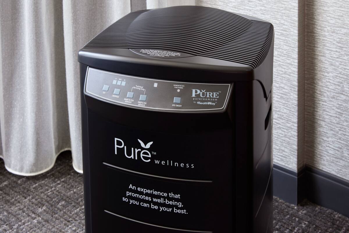 A black wellness device with a control panel, branded "Pure wellness."