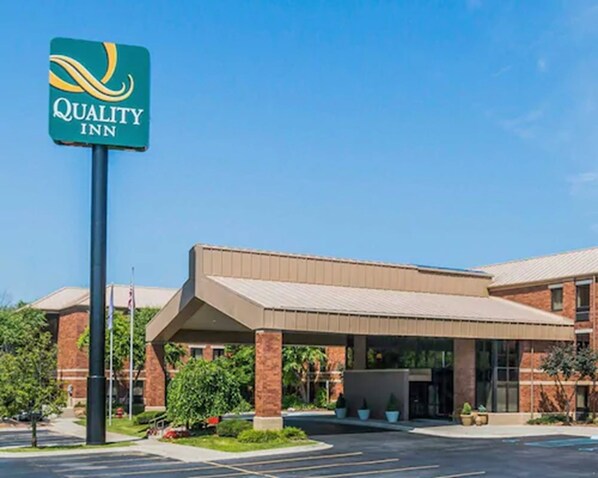 A Quality Inn hotel with a covered entrance and brick exterior.