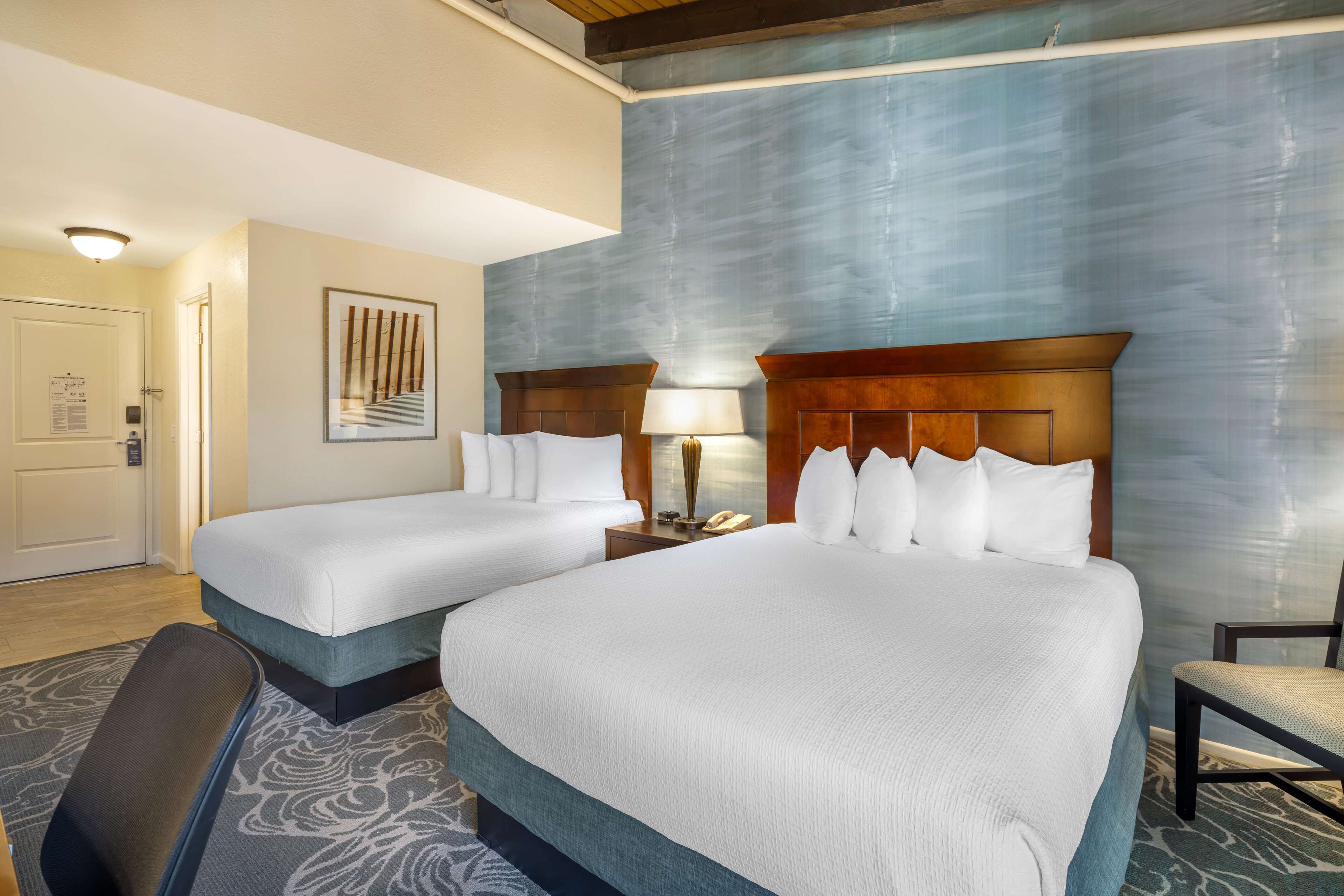 standard room, 2 queen beds, refrigerator, courtyard area | premium bedding, in-room safe, desk, laptop workspace