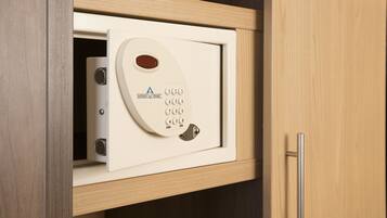 A safe with a keypad and a digital display, housed in a wooden cabinet.