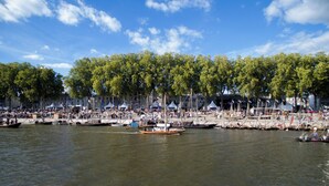 A riverside event with boats and a crowd. - ibis Orléans Centre Gare (Orléans)