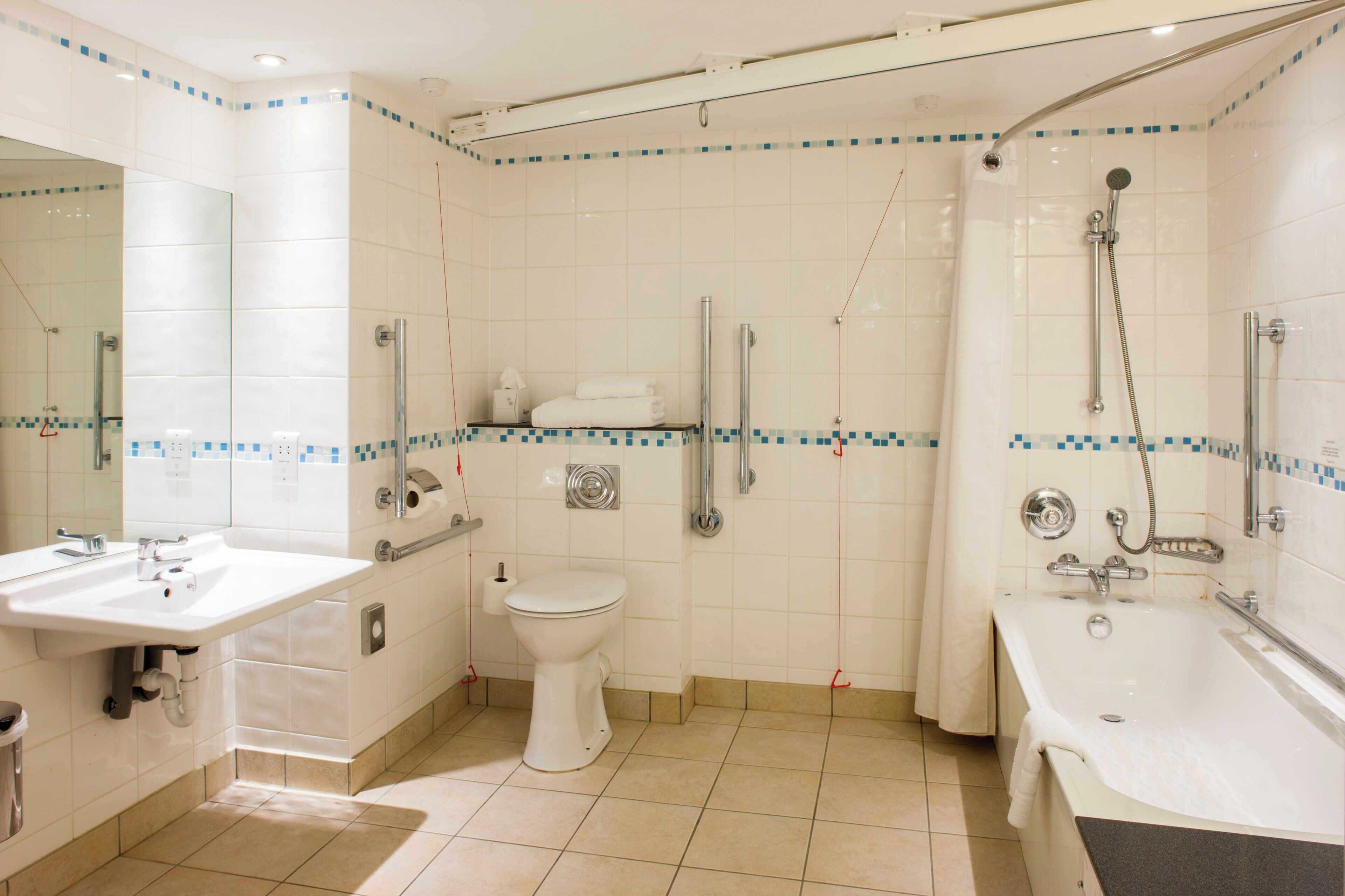 A bathroom with a sink, toilet, and bathtub.