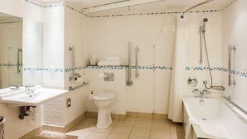 A bathroom with a sink, toilet, and bathtub.