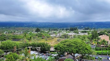 A view of a town with buildings, roads, and greenery.
