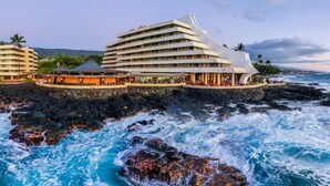 A coastal hotel with multiple floors, a curved roof, and a view of the ocean. - Royal Kona Resort (Kailua-Kona)