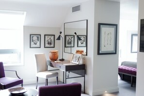 A modern room with a desk, two chairs, a bed, and framed artwork on the walls. - Old Parsonage Hotel (Oxford)