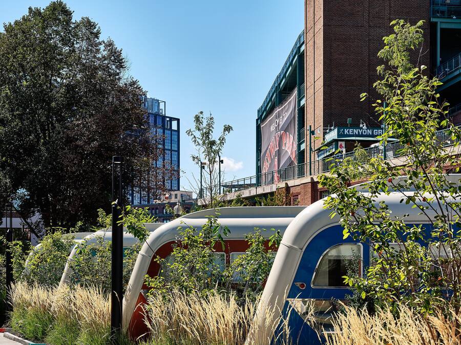 A modern building with a brick facade and a large billboard.