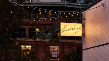 A brick building with a large illuminated sign that reads "RockStage."