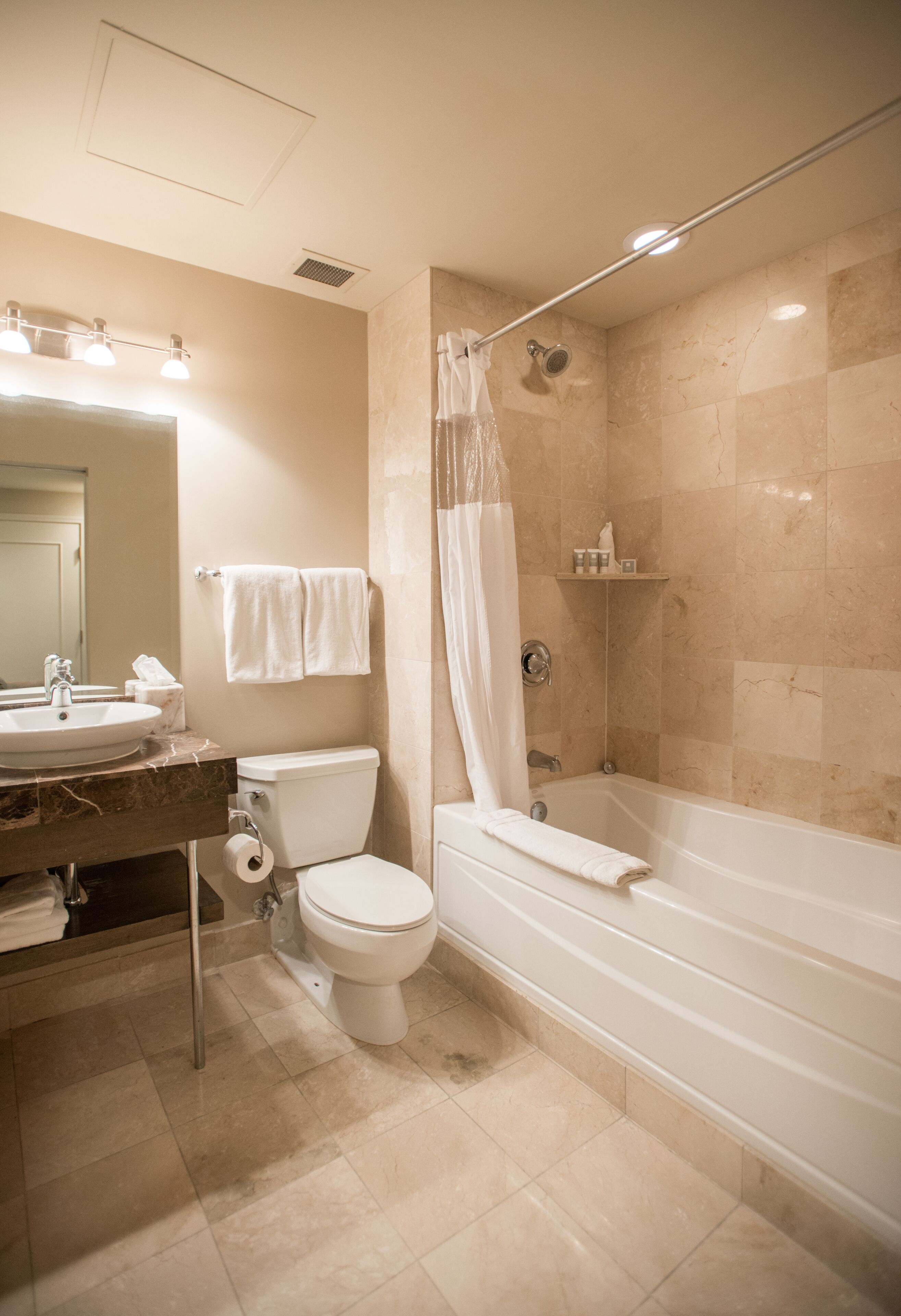 A bathroom with a sink, toilet, and bathtub.