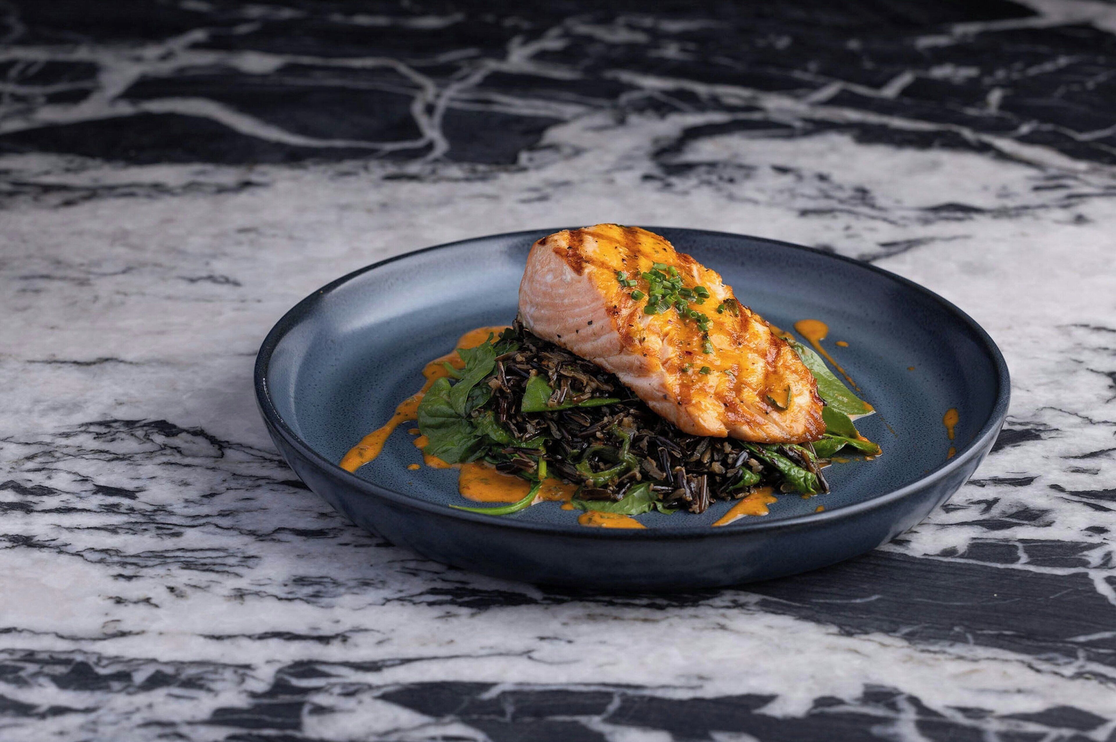 A plate of food on a marble surface.