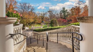A stone staircase with balustrades leading to a garden area with autumn foliage and a gazebo. - Omni Shoreham Hotel Washington DC (Washington)