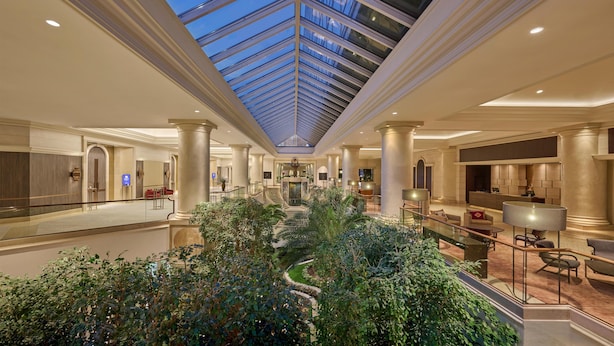 A spacious hotel lobby with a central atrium, multiple levels, and a glass ceiling. - Hyatt Regency Belgrade (Belgrade)
