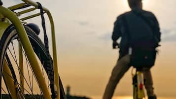 A bicycle with a yellow frame and a person riding it.