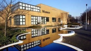 A museum building with a modern architectural design, featuring large windows and a reflective pool in front. - The Hague Marriott Hotel (The Hague)