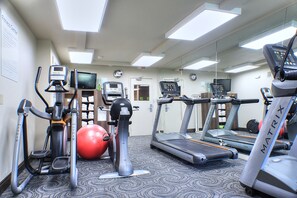 A gym with treadmills, an elliptical, a stationary bike, and a red exercise ball. - Holiday Inn Cody - Convention Center by IHG (Cody)