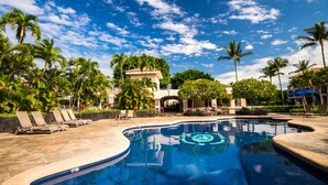 A swimming pool with lounge chairs, palm trees, and a clear blue sky. - Shores at Waikoloa (Waikoloa)
