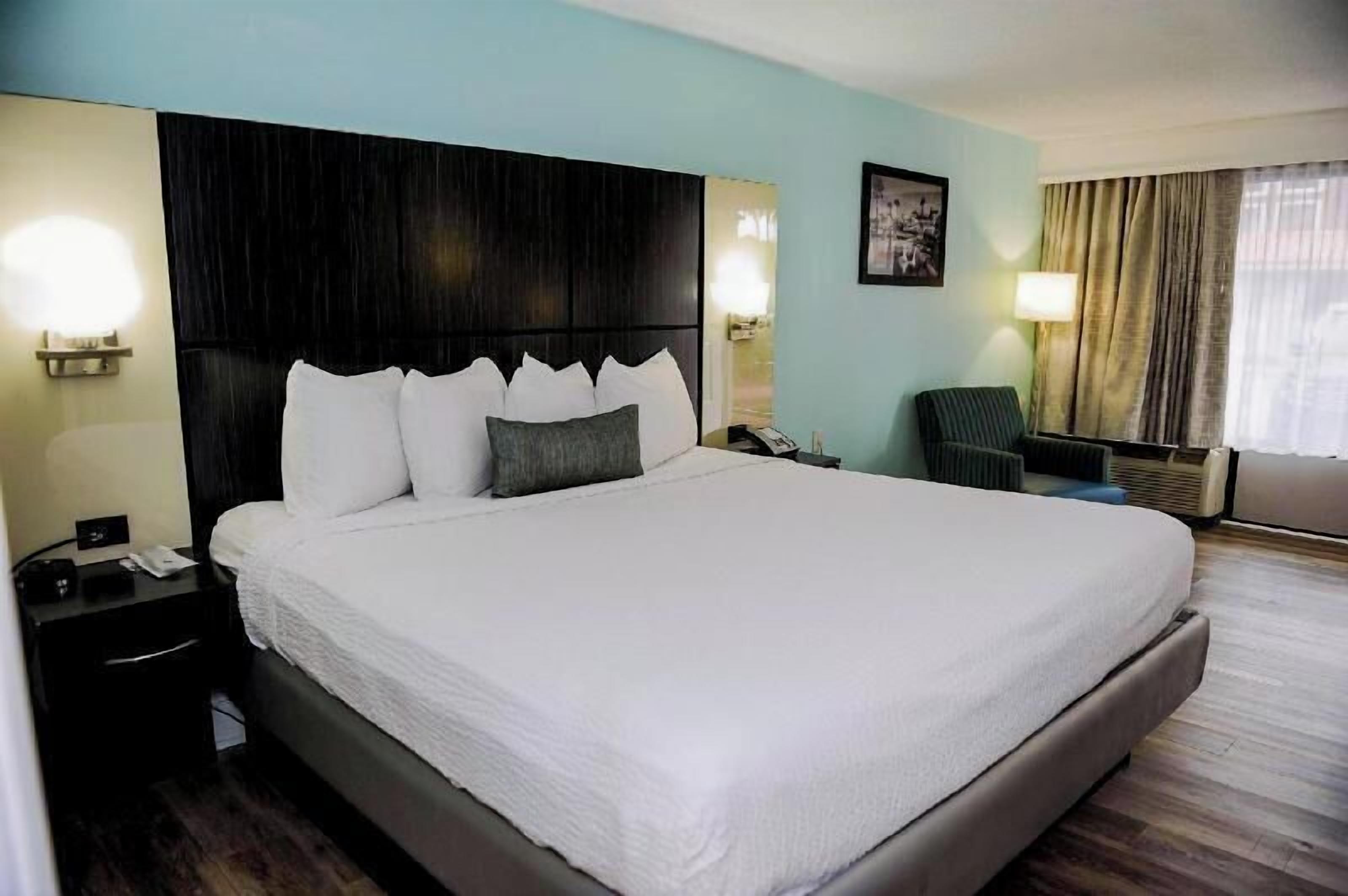 Premium bedding, laptop workspace, blackout curtains, iron/ironing board