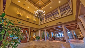 A spacious lobby with a high ceiling, a chandelier, columns, and seating areas. - The Lodge and Club at Ponte Vedra Beach (Ponte Vedra Beach)