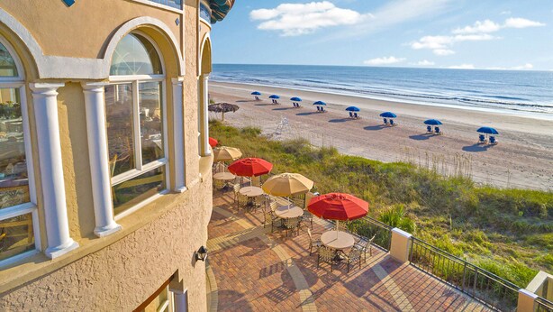 A beachside patio with outdoor seating and umbrellas overlooking the ocean. - The Lodge and Club at Ponte Vedra Beach (Ponte Vedra Beach)