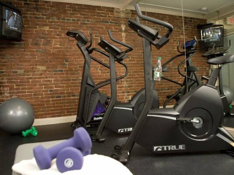 A gym with treadmills, a stationary bike, and exercise balls.