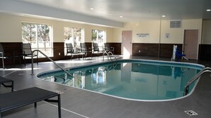 A pool area with lounge chairs, a no lifeguard on duty sign, and a door. - Fairfield by Marriott Mt Pleasant (Mount Pleasant)