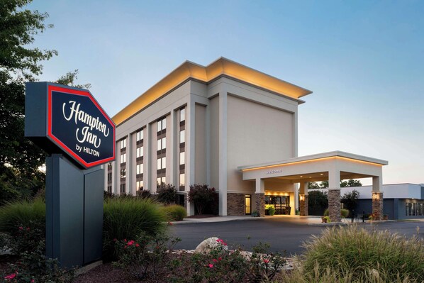 A Hampton Inn by Hilton with a modern building and a welcoming entrance.