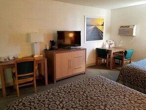 Relax in a cozy space with a single bed, desk, and TV.